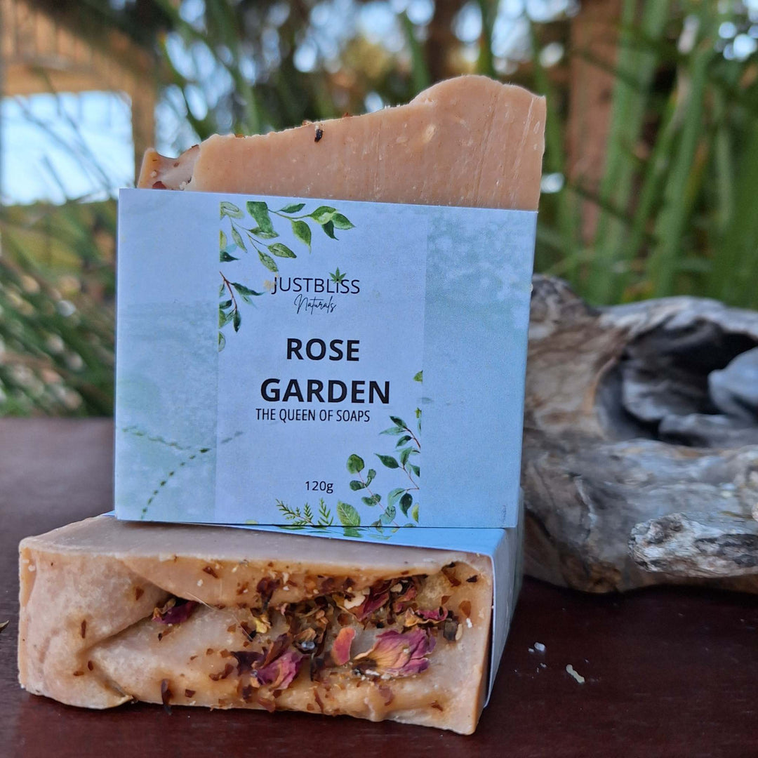 Artisan soap bar with packaging, displayed outdoors, featuring natural ingredients and Rose Garden scent.