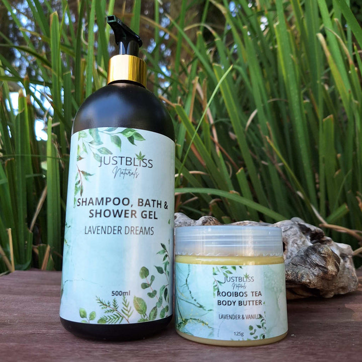 COMBO BODY WASH & BODY BUTTER set with shampoo, bath, and shower gel alongside Rooibos body butter, showcased amid lush greenery.