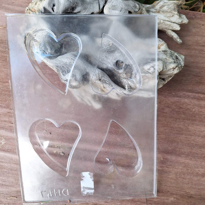 Heart-shaped soap mold from a DIY glycerin soap making kit with clear compartments for crafting homemade soaps.