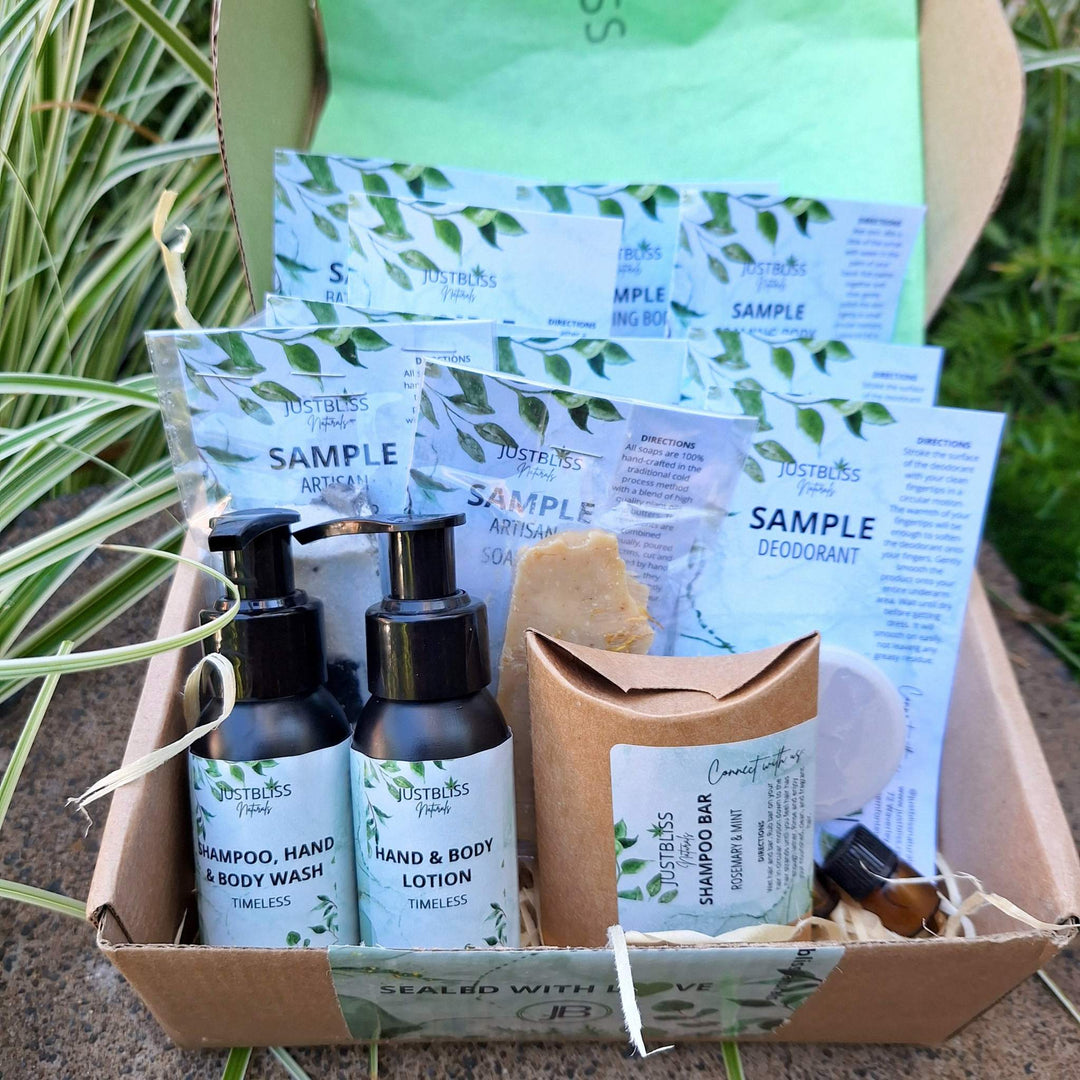 Luxury plant-based skincare starter kit with samples of hand and body wash, lotion, shampoo bar, body scrub, body butter, artisan soap, deodorant, bath mousse, facial oil, and prickly pear seed oil.