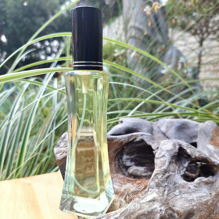 50ml oil-based floral perfume for women in a sleek bottle, surrounded by natural greenery.