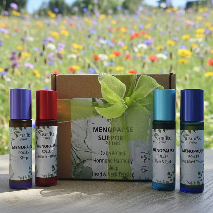 Menopause support roller bottles with a branded box on a wooden surface.