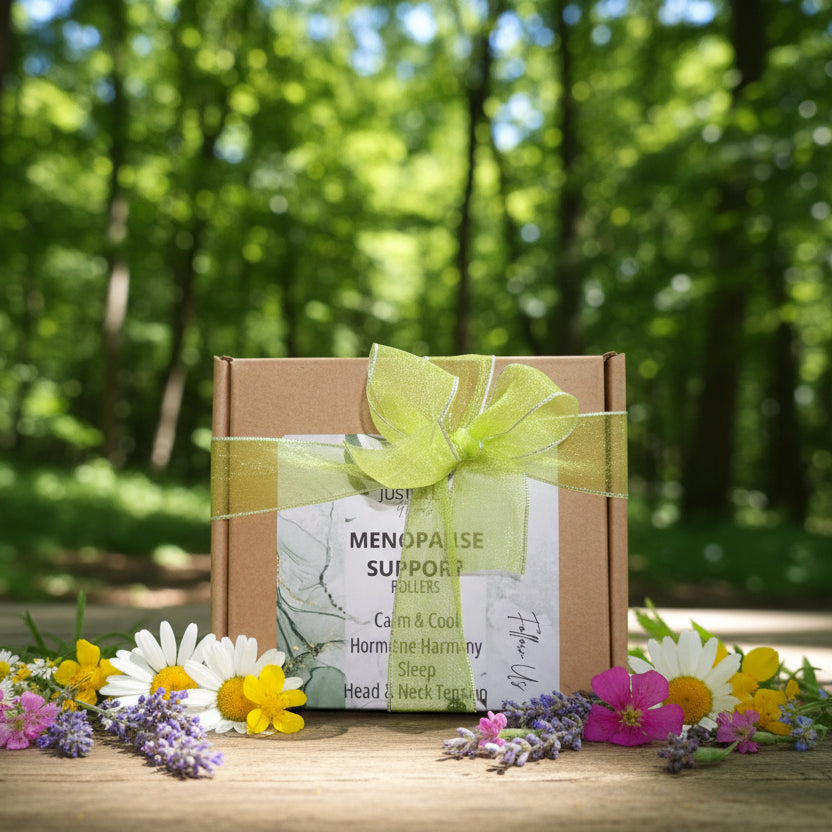 Box of Menopause Support Rollers with a green ribbon on a wooden surface