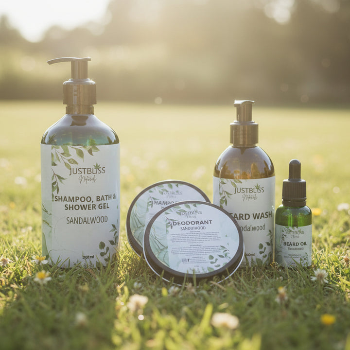 Collection of JustBliss Naturals skincare products on a wooden surface with a green box in the background.