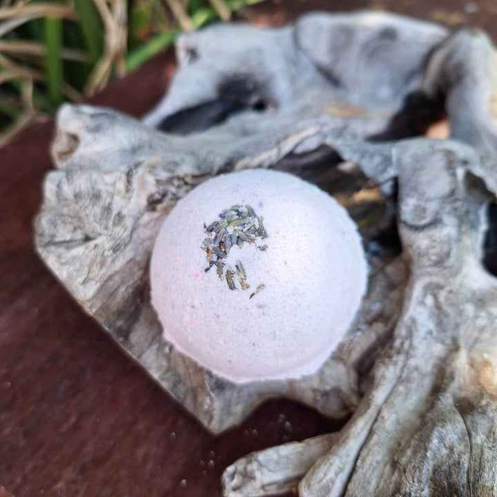 Christmas themed bath bomb with lavender and hemp oil on rustic wood background.