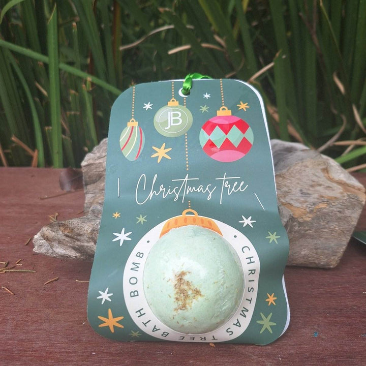 Christmas themed bath bomb with festive packaging featuring hanging ornaments.