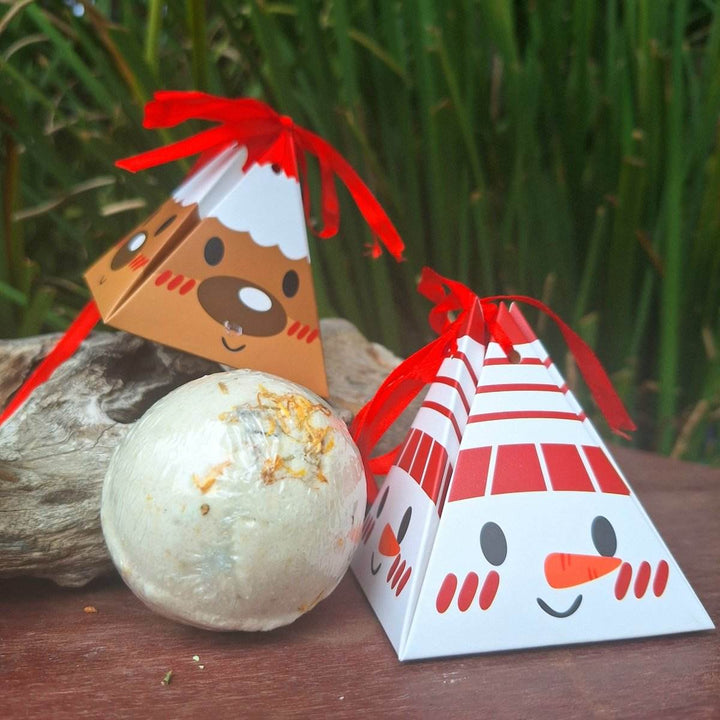 Christmas themed bath bomb with festive packaging, infused with lavender oil and hemp oil for a relaxing bath experience.