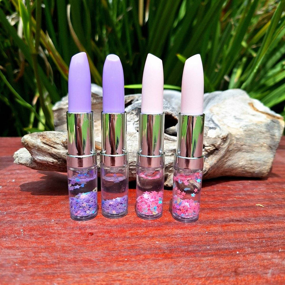 Lipstick pen set with vibrant colors on a wooden surface.
