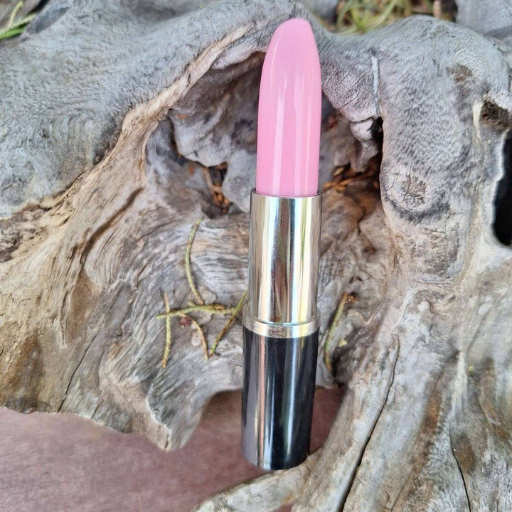 Lipstick Pen with ink in pink shade on rustic background.