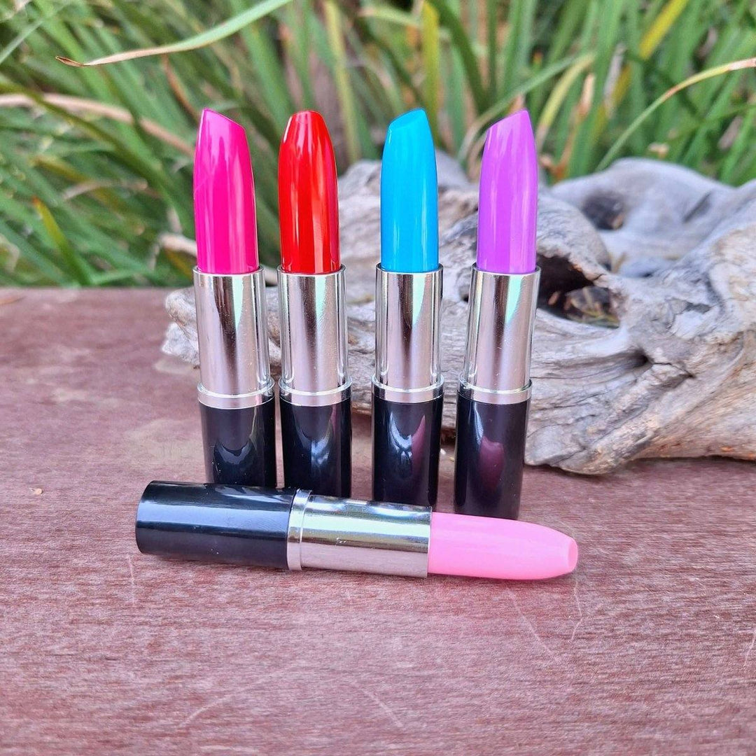 Lipstick Pen in vibrant colors on a wooden surface.
