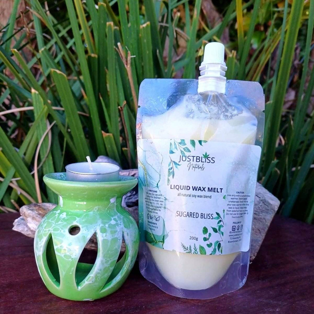 Aromatherapy Gift Box 2 with essential oil burner, tea light candle, and Sugared Bliss liquid wax melt against outdoor backdrop.