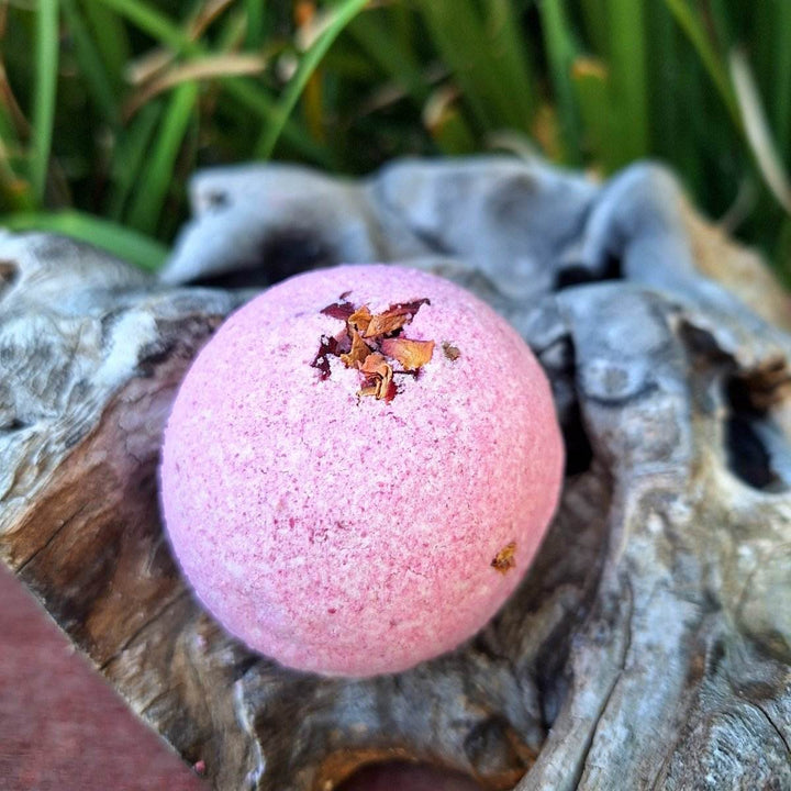 Rose Garden Romantic Gift Box with geranium-scented bath bomb on driftwood.