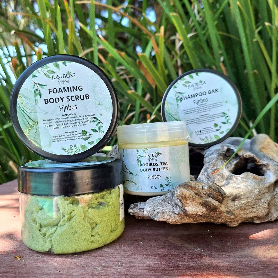 Fijnbos Gift Box with body scrub, body butter, and shampoo bar displayed outdoors.