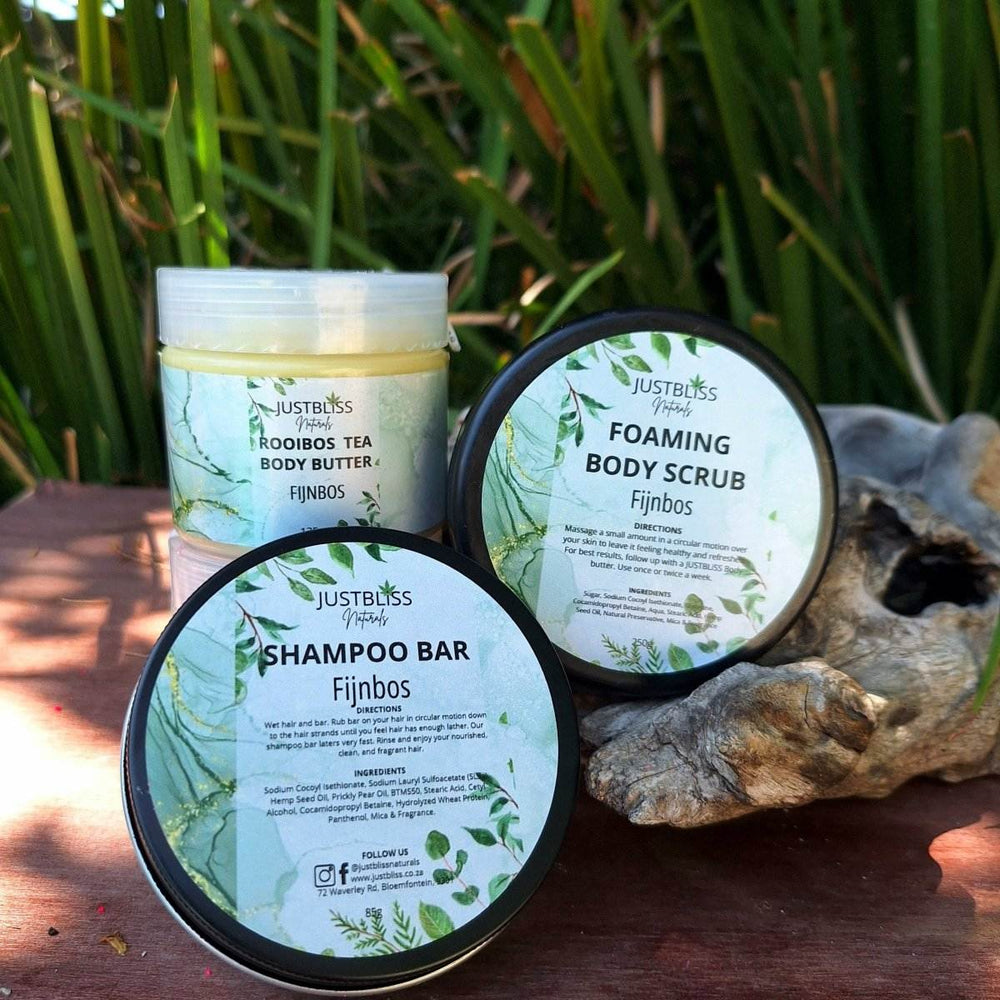 Fijnbos Gift Box with body butter, body scrub, and shampoo bar displayed outdoors.