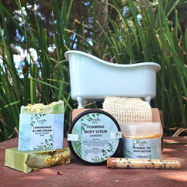 Spa gift box with bath essentials including body scrub, bath salt, artisan soap, sisal soap saver, Rooibos tea body butter, and small bath.