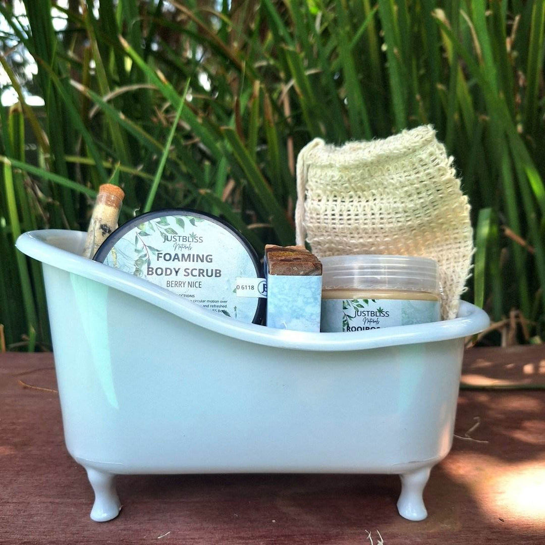 Limited edition spa gift box in a mini bathtub featuring body scrub, bath salt, artisan soap, sisal soap saver, and rooibos body butter.