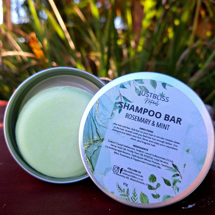 Eco-friendly Shampoo Bar in reusable tin with rosemary and mint for hair care.