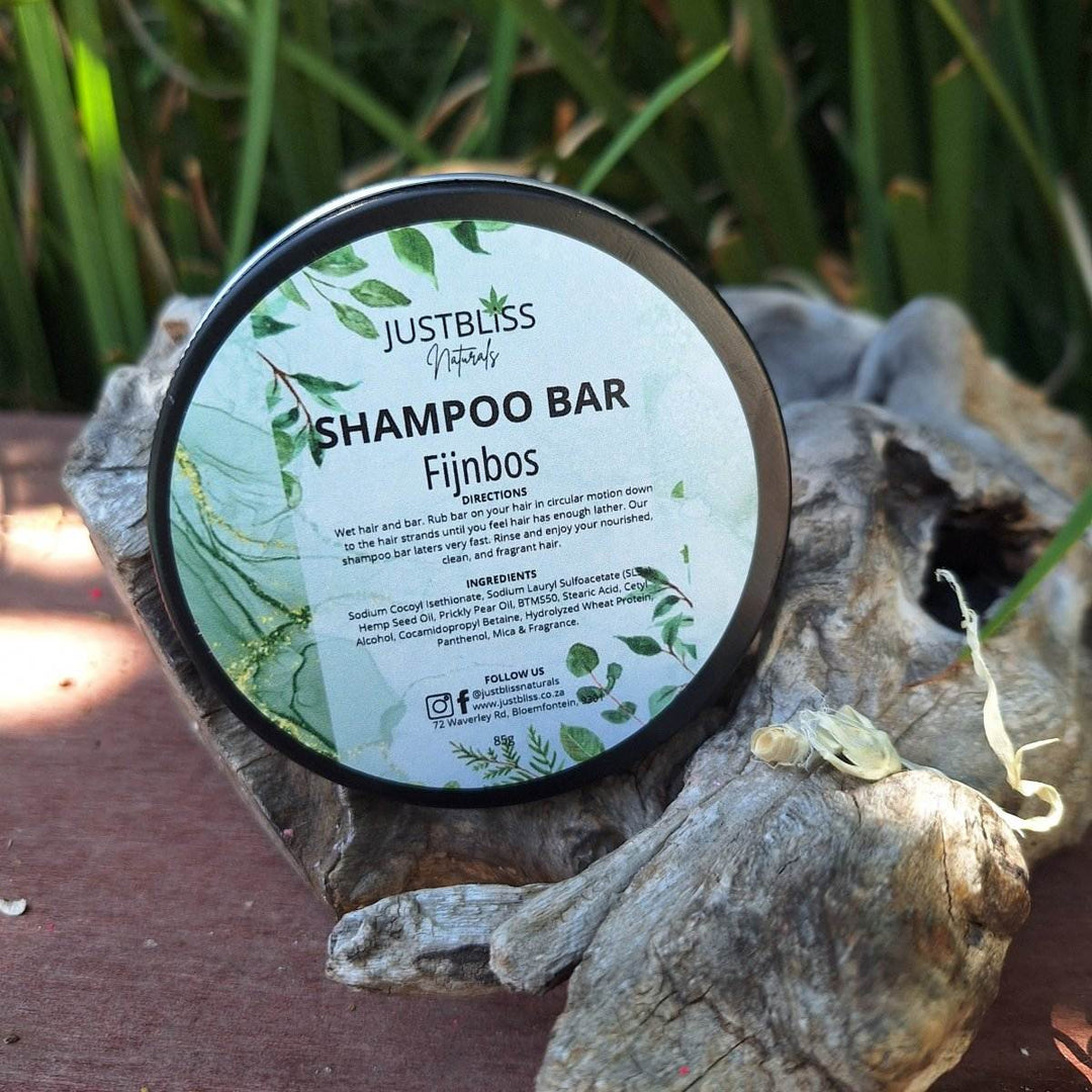 Eco-friendly Fijnbos Shampoo Bar in reusable tin on natural wood surface.