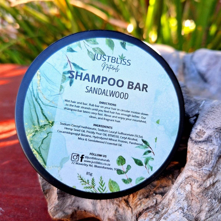 Eco-friendly sandalwood Shampoo Bar in reusable tin, crafted with plant-based ingredients for all hair types.