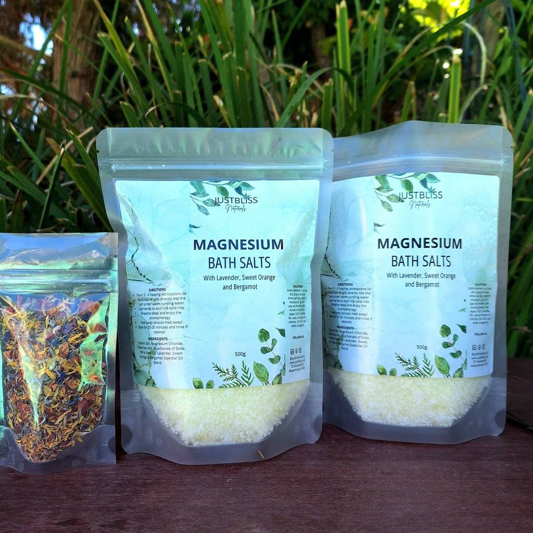 Magnesium Bath Salt packets with calming lavender, orange, and bergamot, displayed outdoors.