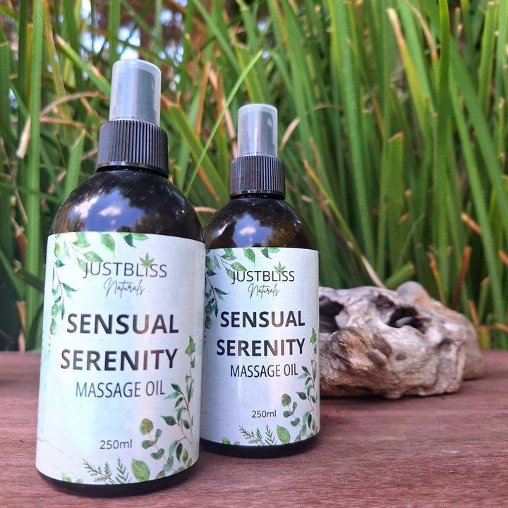 Sensual Serenity Massage Oil bottles with green foliage in the background, 250ml size.