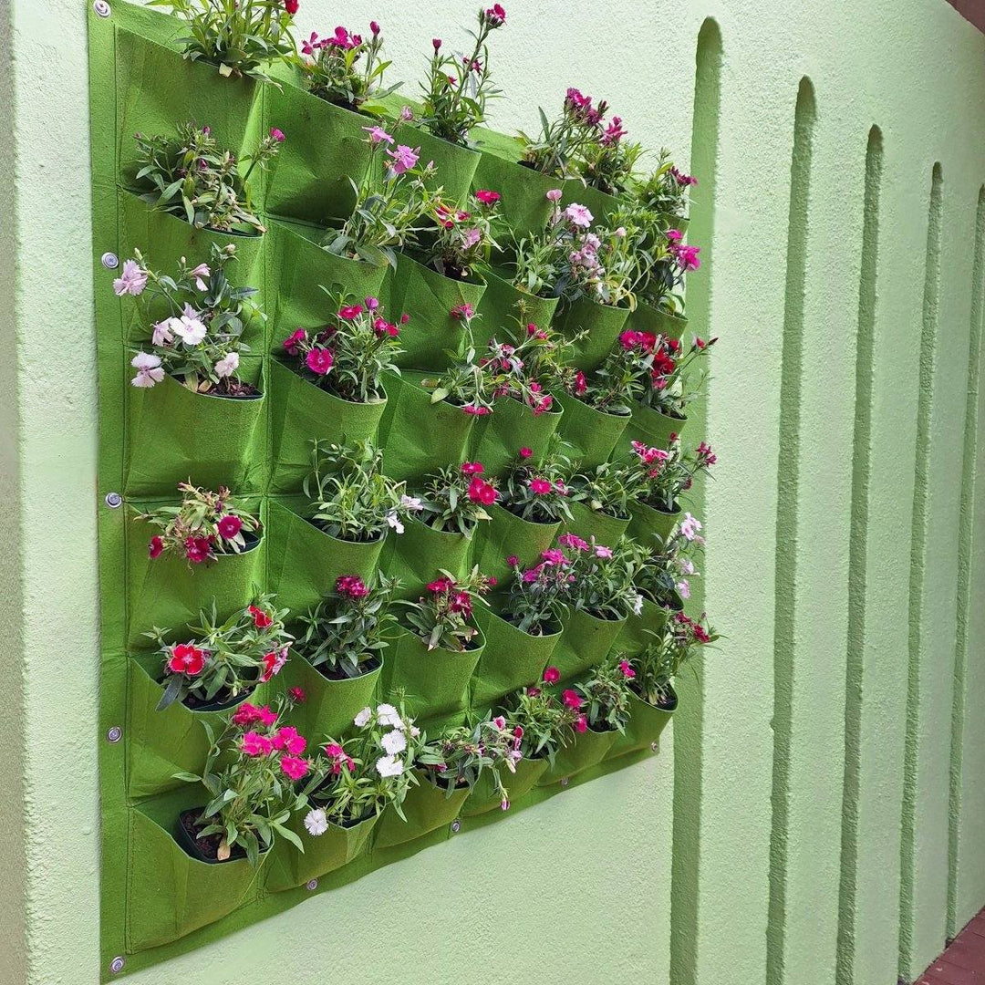 Vertical garden living wall planter with 36 green pockets, holding vibrant flowers and enhancing space.