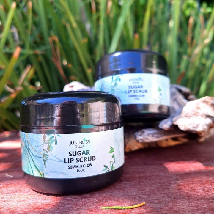 Sugar Scrub (Summer Glow) lip exfoliant on display in an outdoor setting.