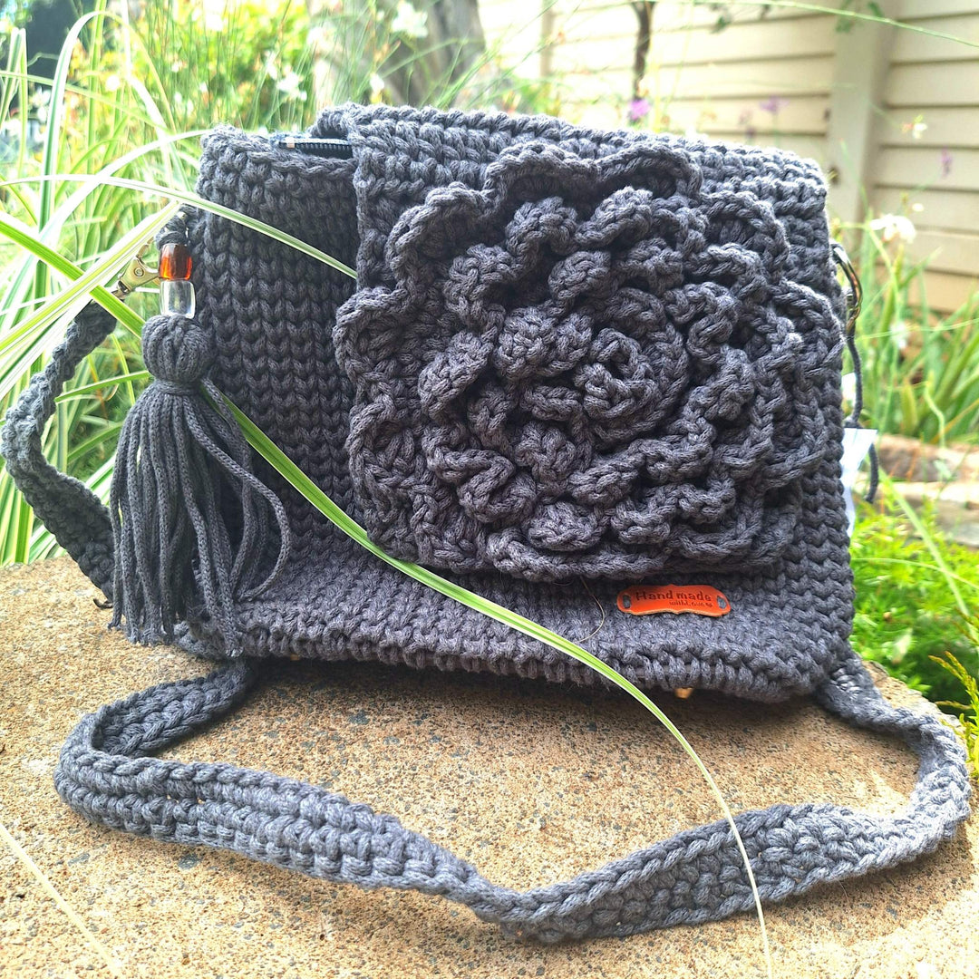 Hand-crafted handbag made of cotton wool with floral design, showcasing unique, hand-stitched craftsmanship.