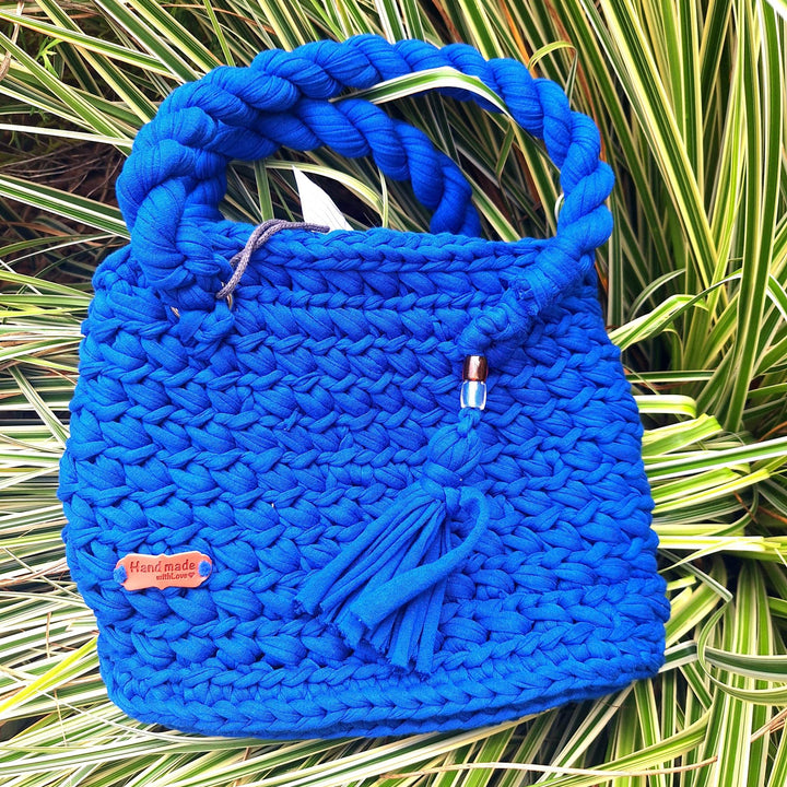 Hand-crafted handbag made with cotton wool, featuring hand-stitched design and tassel embellishment.