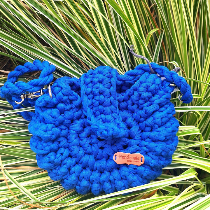Hand-crafted handbag made of cotton wool with braided handle, showcasing intricate stitching.
