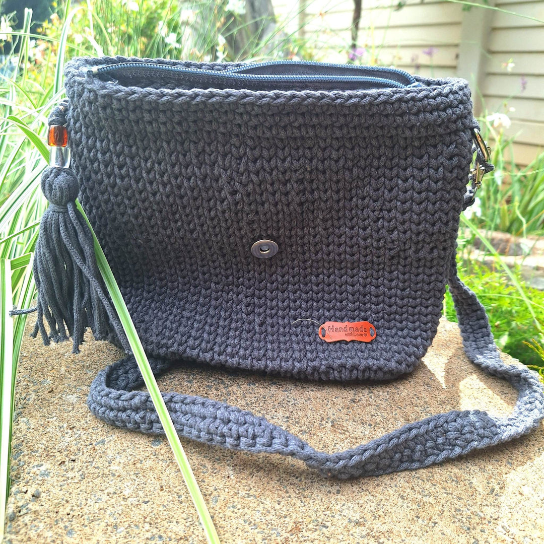 Hand-crafted handbag made of cotton wool with hand-stitched design, featuring a spacious interior and durable construction.