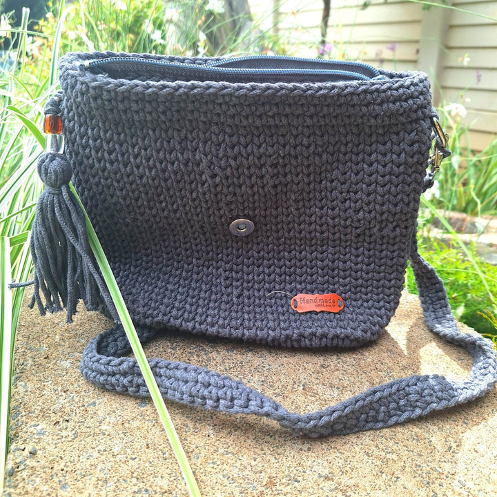 Hand-crafted handbag made of cotton wool with hand-stitched design, featuring a spacious interior and durable construction.