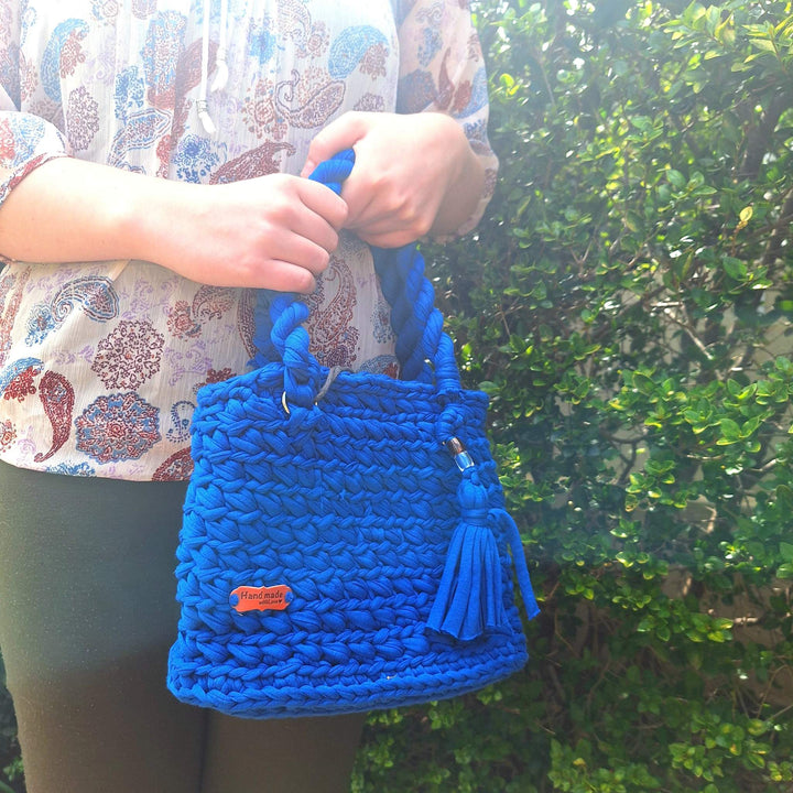 Hand-crafted handbag made from cotton wool, featuring a unique design and hand-stitched details, perfect for elevating your style.