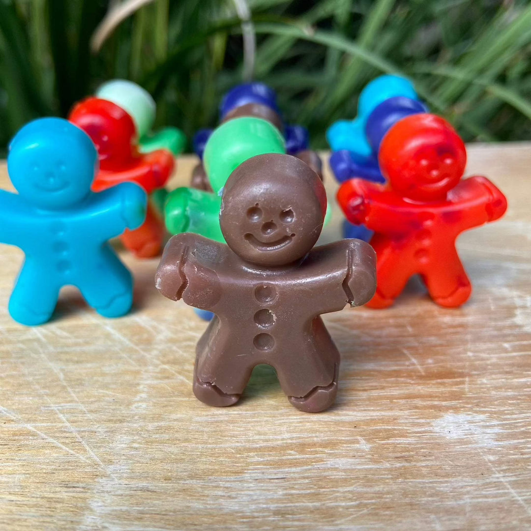Colorful gingerbread man soap bars made from shea butter, perfect for Christmas.