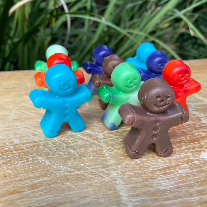 Colorful gingerbread man soap bars made from Shea butter, perfect for Christmas celebrations.