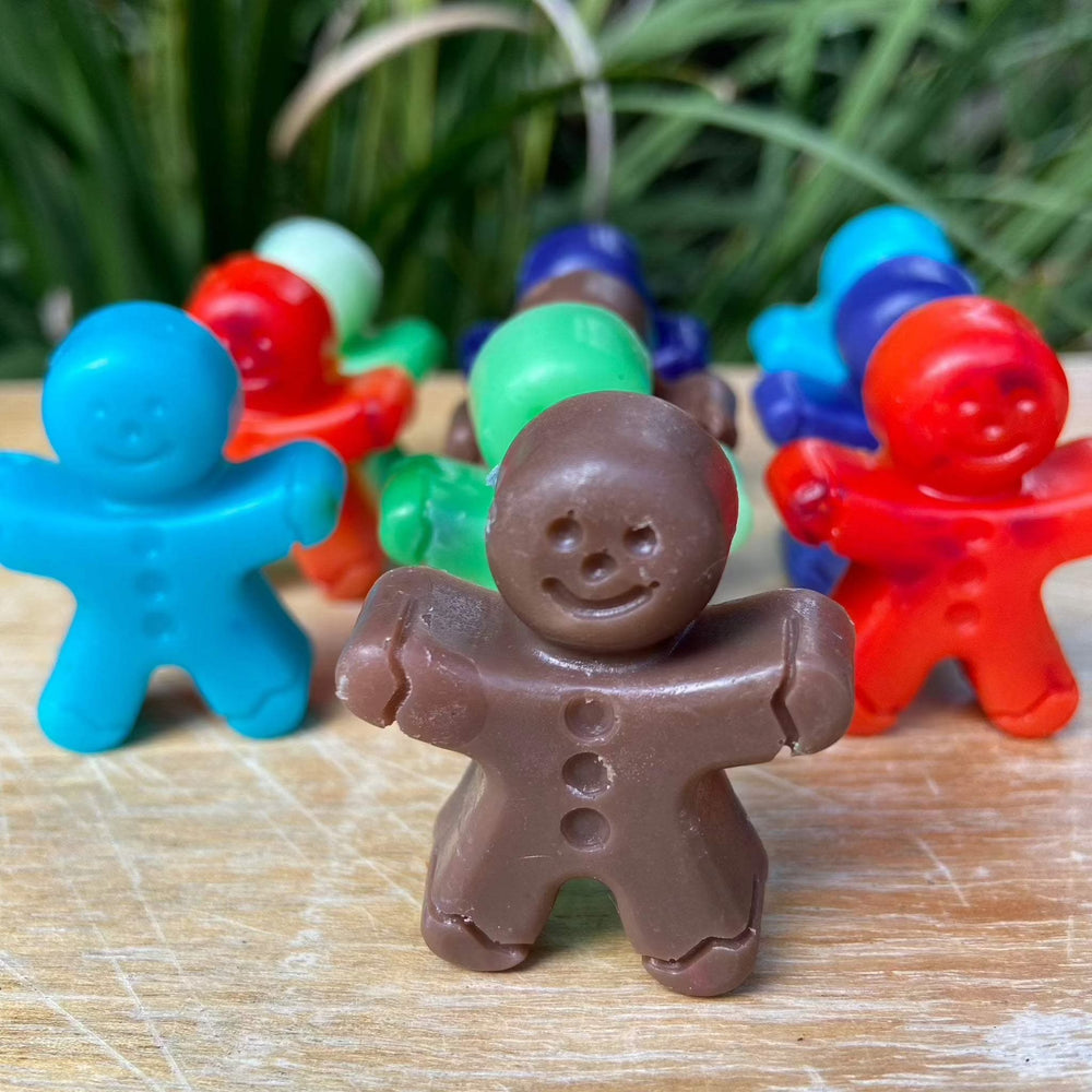 Gingerbread man shaped soap bars in various colors made from Shea butter.