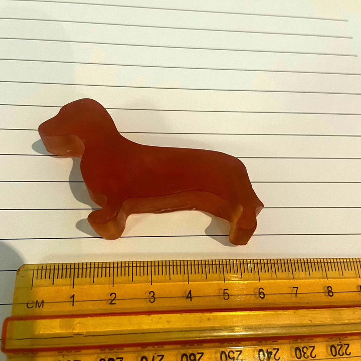 Sausage dog-shaped glycerine soap bar with ruler for scale.